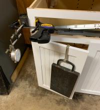 Weight test on cabinet door.
