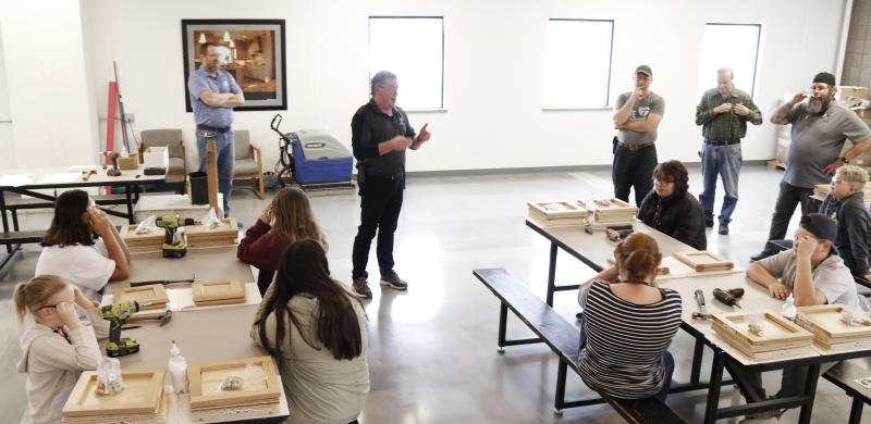 Tom Christensen, Environment Health and Safety Manager, gives a class about safety and quality before the fifth-graders dive into the Build-A-Cabinet project on Kids Switch Day