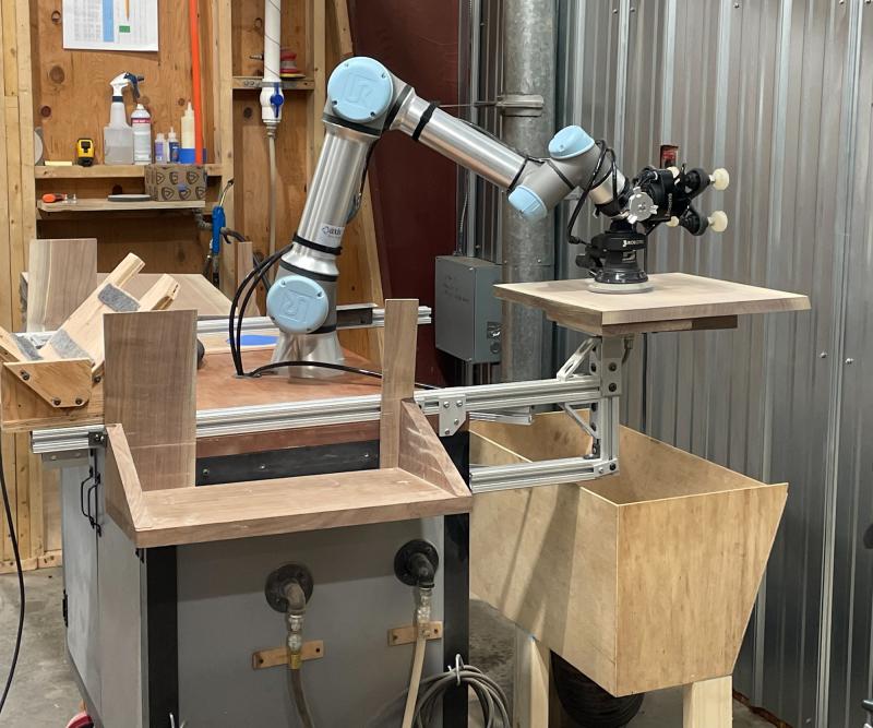 Andrew Pearce Bowls added a vacuum table controlled by the digital inputs and outputs in the cobot controller. When the boards are brought over to the UR5e cobot, they have been pre-sanded slightly and sprayed with water to raise the grain in order for the cobot to finish sand them.