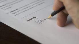 Signing paperwork - Pexels